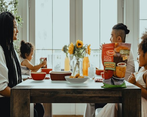A family sitting together at the dining table eating dinner