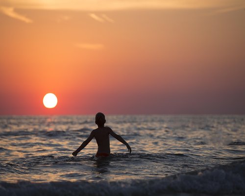Person walking in an urban setting during sunset